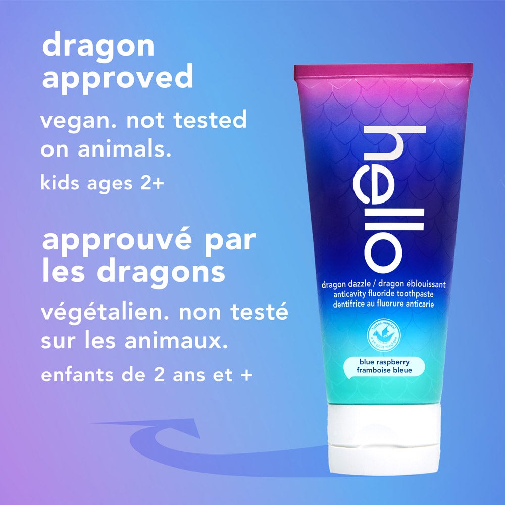 A tube of hello dragon dazzle blue raspberry fluoride toothpaste stands upright on a light blue gradient background. The text beside it reads, "dragon approved, vegan, not tested on animals, kids ages 2+."