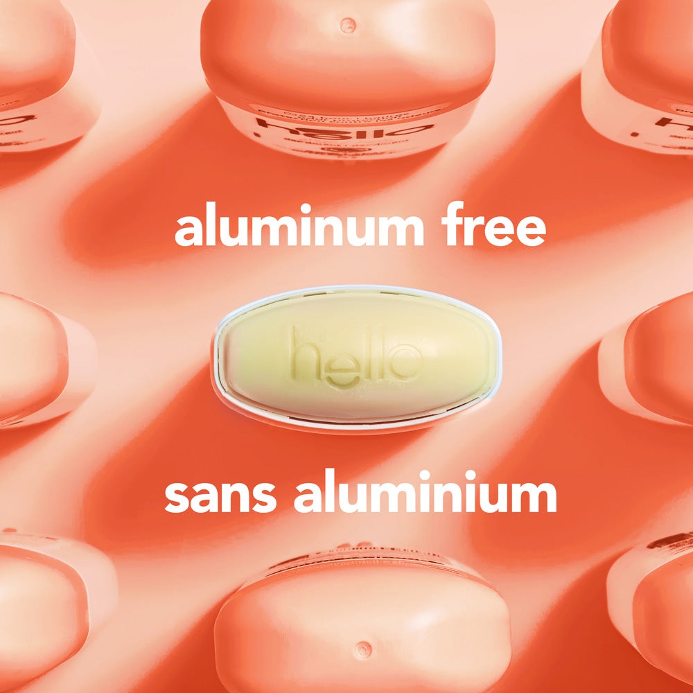A top-down view of several orange deodorant containers arranged around a central  oval container embossed with the word "hello." The image includes the text "aluminum free."